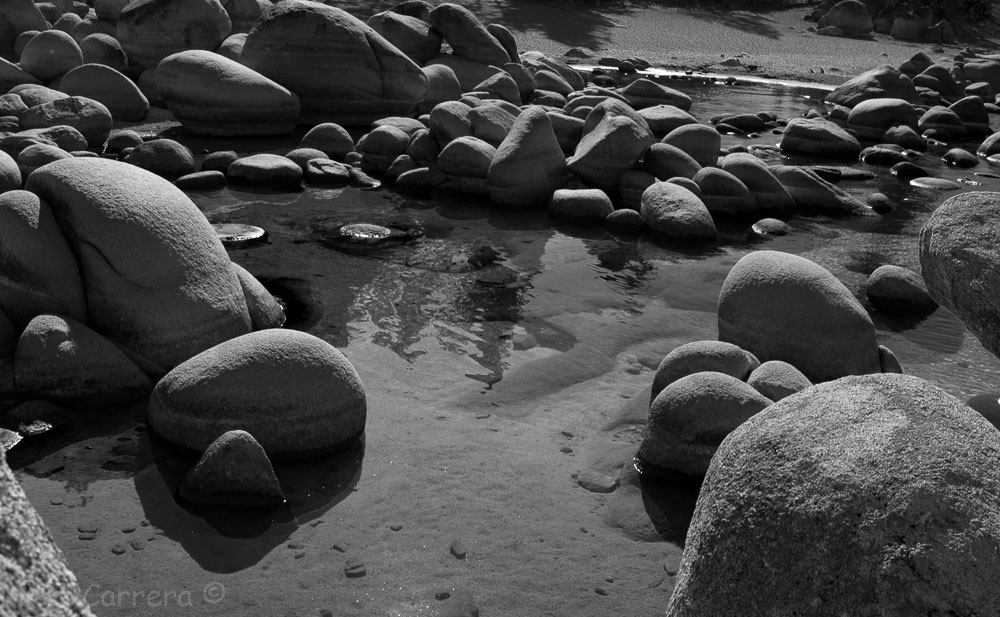 A black and white image of boulders in Lake Tahoe, Sand Harblr